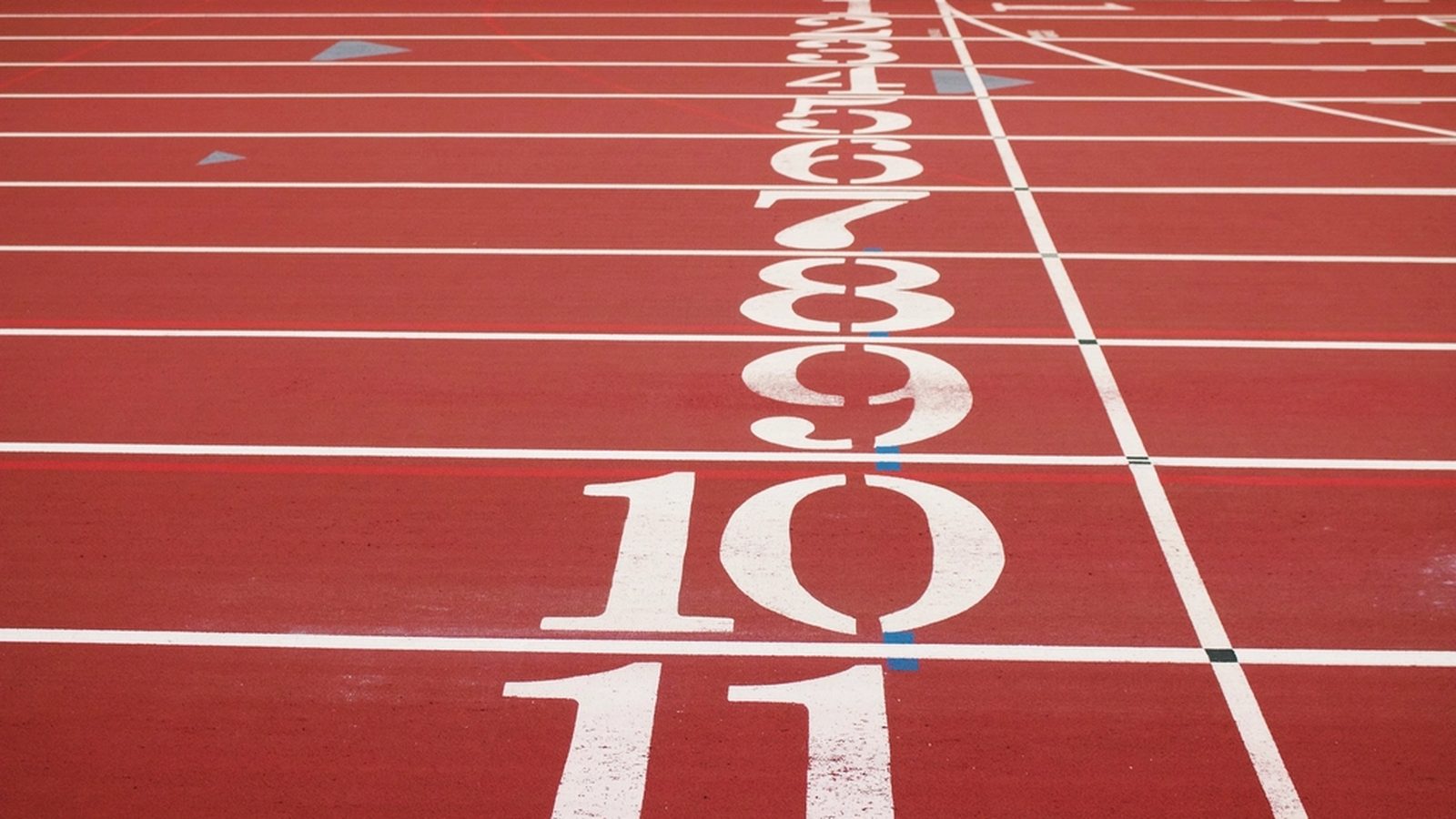 Numbered lanes at the starting line of a running track